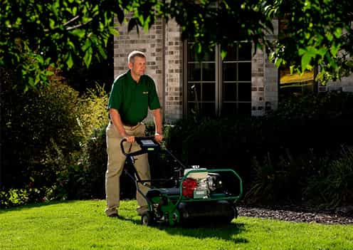 Weed Man technician aerating lawn